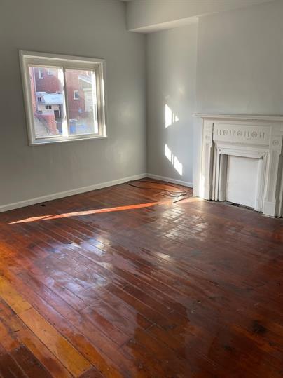 5220 Holmes Street Pittsburgh, PA 15201 - Photo 3 of 18 a view of empty room with window and wooden floor