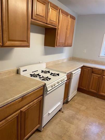 5220 Holmes Street Pittsburgh, PA 15201 - Photo 6 of 18 a kitchen with granite countertop cabinets and white appliances