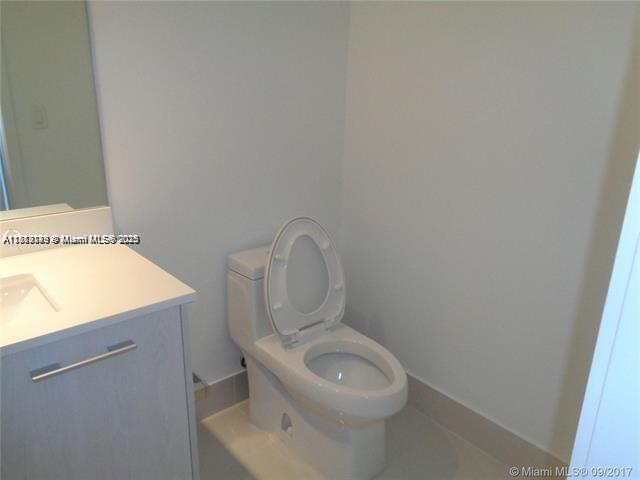 45 Southwest 9th Street, Unit 2709 Miami, FL 33130 - Photo 12 of 34 a white toilet sitting next to a white sink