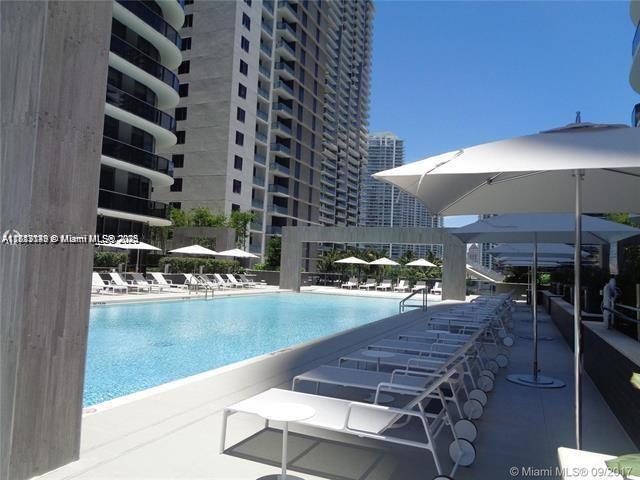 45 Southwest 9th Street, Unit 2709 Miami, FL 33130 - Photo 19 of 34 a view of a patio with a table and chairs under an umbrella