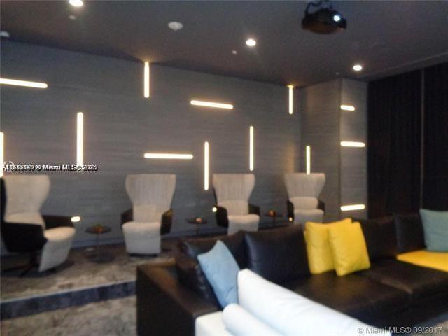 45 Southwest 9th Street, Unit 2709 Miami, FL 33130 - Photo 25 of 34 a living room with furniture and a lamp