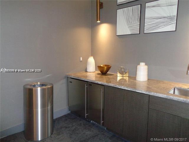 45 Southwest 9th Street, Unit 2709 Miami, FL 33130 - Photo 28 of 34 a bathroom with a sink and a mirror