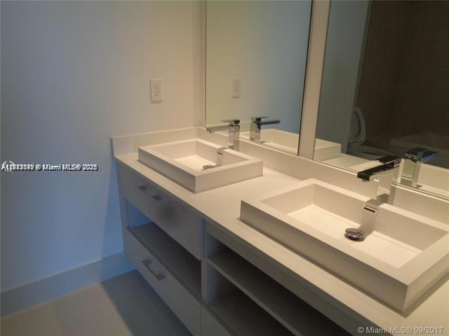 45 Southwest 9th Street, Unit 2709 Miami, FL 33130 - Photo 10 of 34 a bathroom with a sink and a mirror