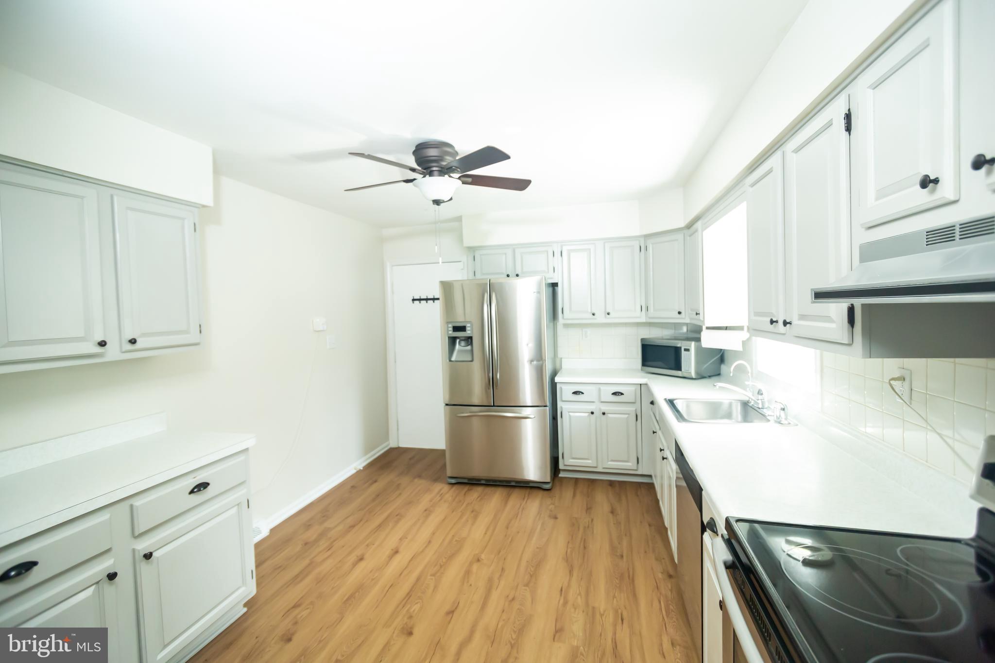 11623 Rivershore Drive Dunkirk, MD 20754 - Photo 14 of 49 a kitchen with a refrigerator a sink and dishwasher a stove with wooden floor