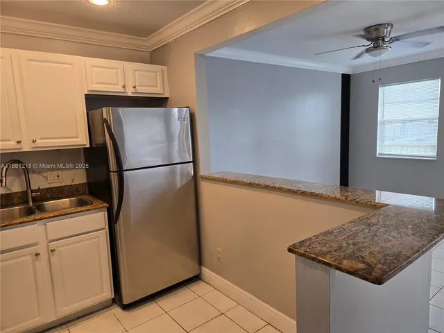 a kitchen with appliances cabinets and a counter top space