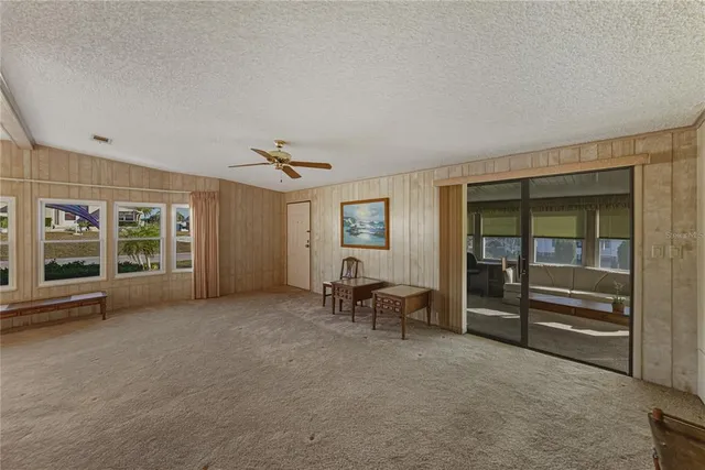 an empty room with furniture and windows