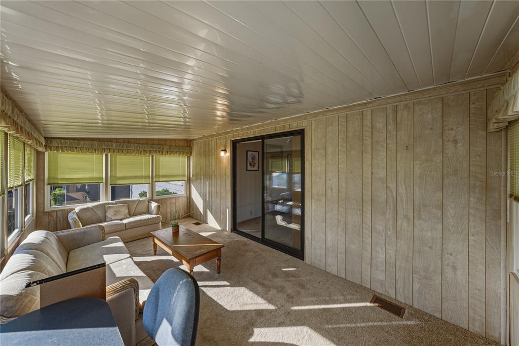 14921 Rialto Avenue Brooksville, FL 34613 - Photo 14 of 55 a living room with furniture and large windows