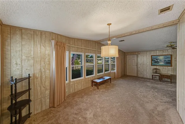 a view of a room with cabinet mirror and windows
