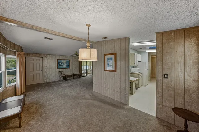 a view of a room with entryway windows and cabinet