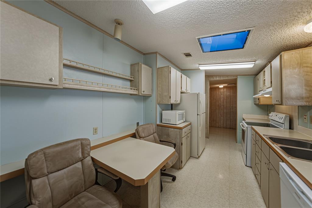14921 Rialto Avenue Brooksville, FL 34613 - Photo 21 of 55 a kitchen with stainless steel appliances cabinets and wooden floor