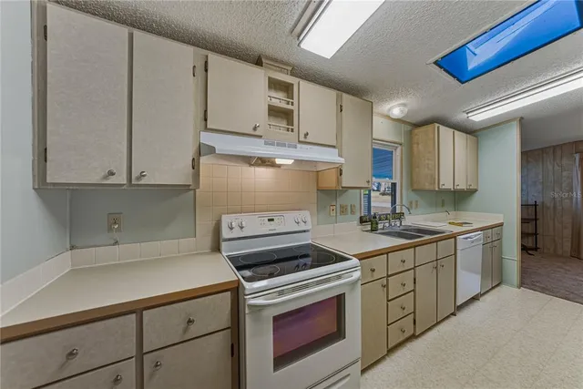 a kitchen with a sink stove and cabinets