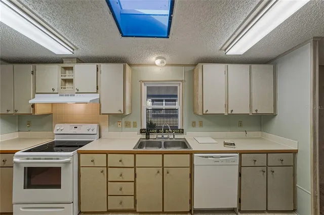 a kitchen with cabinets appliances and a window