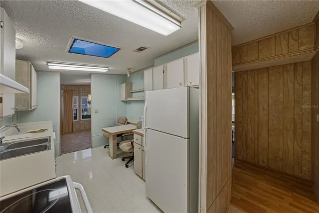 a kitchen with a refrigerator a stove and a sink