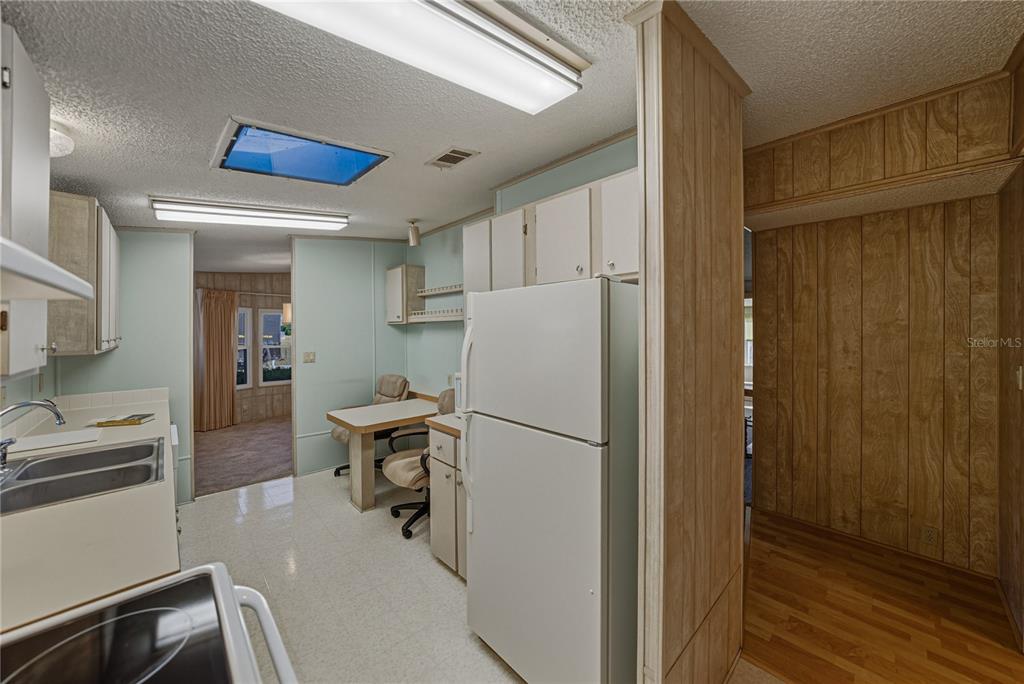 14921 Rialto Avenue Brooksville, FL 34613 - Photo 24 of 55 a kitchen with a refrigerator a stove and a sink