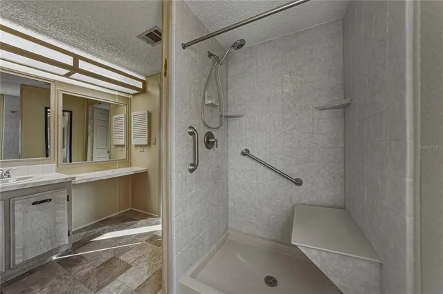 a bathroom with a sink and mirror with toilet
