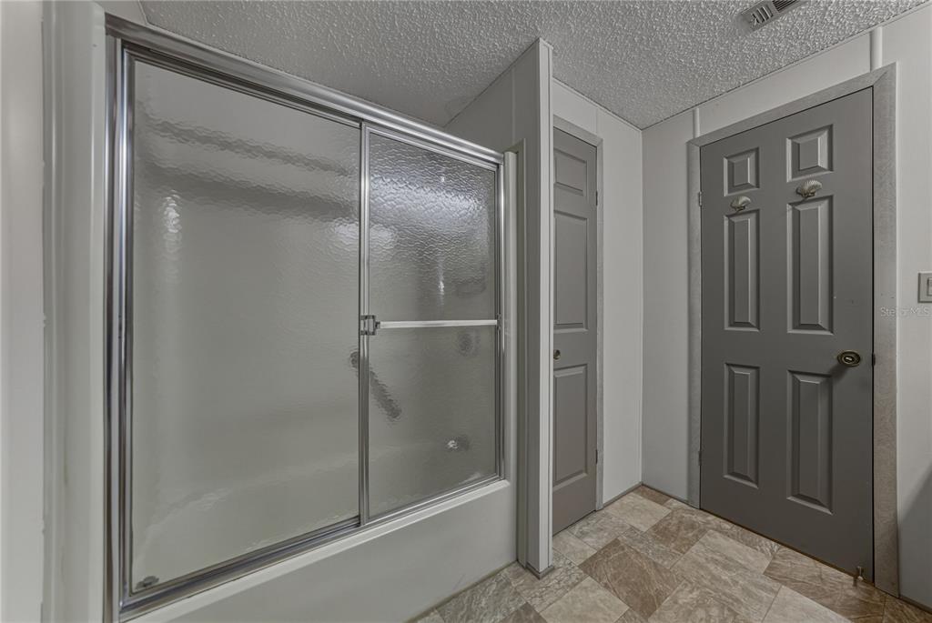 14921 Rialto Avenue Brooksville, FL 34613 - Photo 39 of 55 a bathroom with a glass shower door