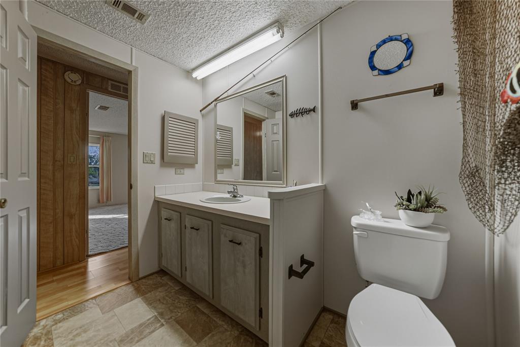 14921 Rialto Avenue Brooksville, FL 34613 - Photo 40 of 55 a bathroom with a toilet sink and mirror
