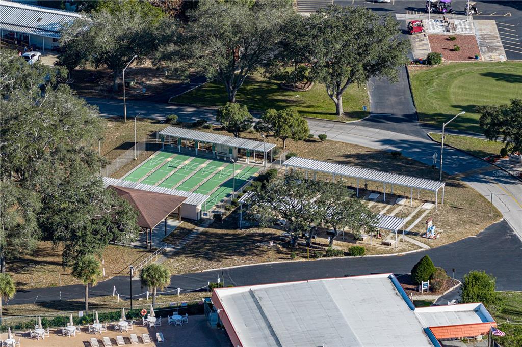14921 Rialto Avenue Brooksville, FL 34613 - Photo 52 of 55 an aerial view of a house with a garden and lake view