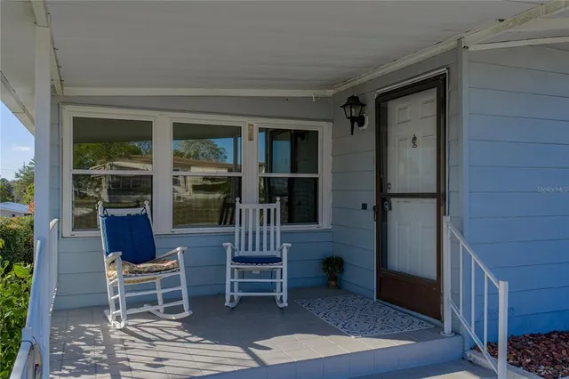 a porch with seating space and outdoor view