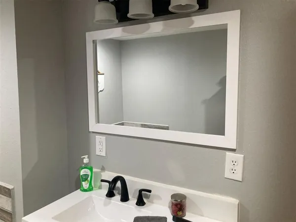 a bathroom with a sink and a window