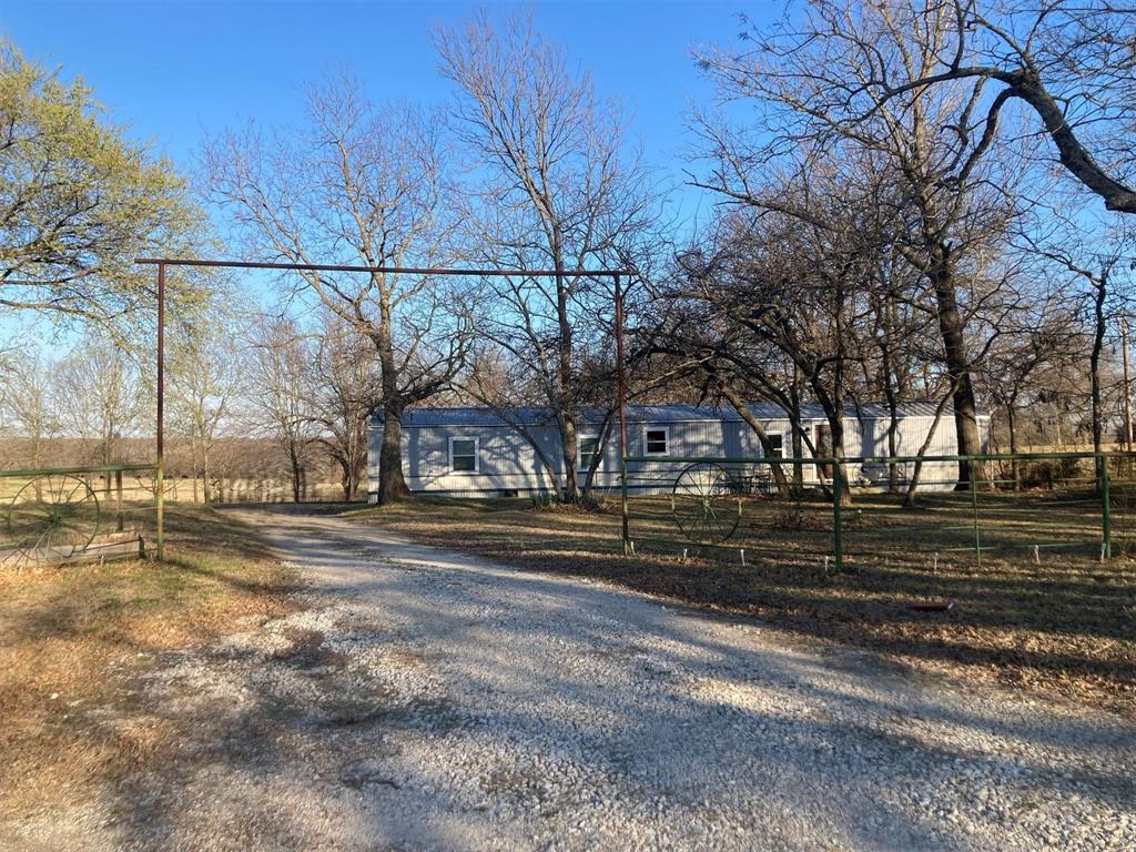 248 Shaffer Road Denison, TX 75021 - Photo 3 of 39 a view of a yard with wooden fence
