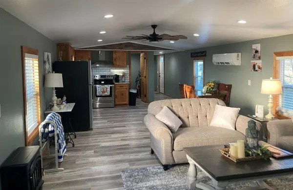 a living room with furniture and kitchen view
