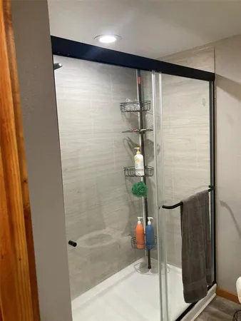 a bathroom with a glass shower door