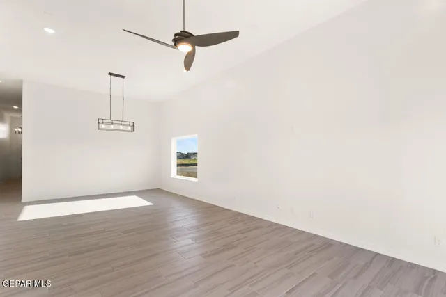 a view of a room with wooden floor closet and windows