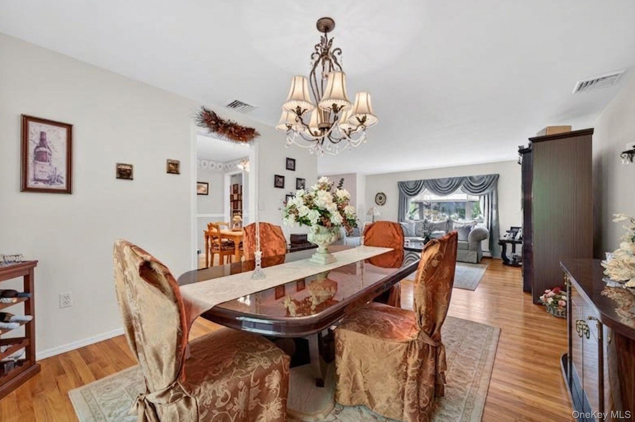 16 Woodward Road Slate Hill, NY 10973 - Photo 20 of 37 a view of a dining room with furniture a chandelier and wooden floor