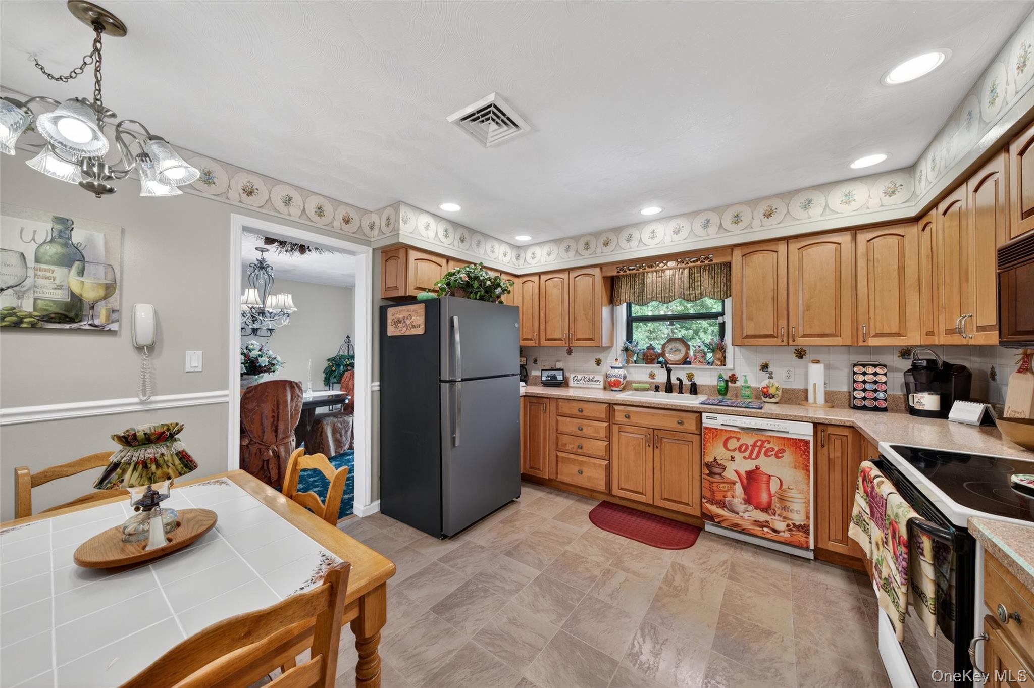 16 Woodward Road Slate Hill, NY 10973 - Photo 22 of 37 a kitchen with stainless steel appliances granite countertop a refrigerator a sink dishwasher a stove and a dining table with wooden floor
