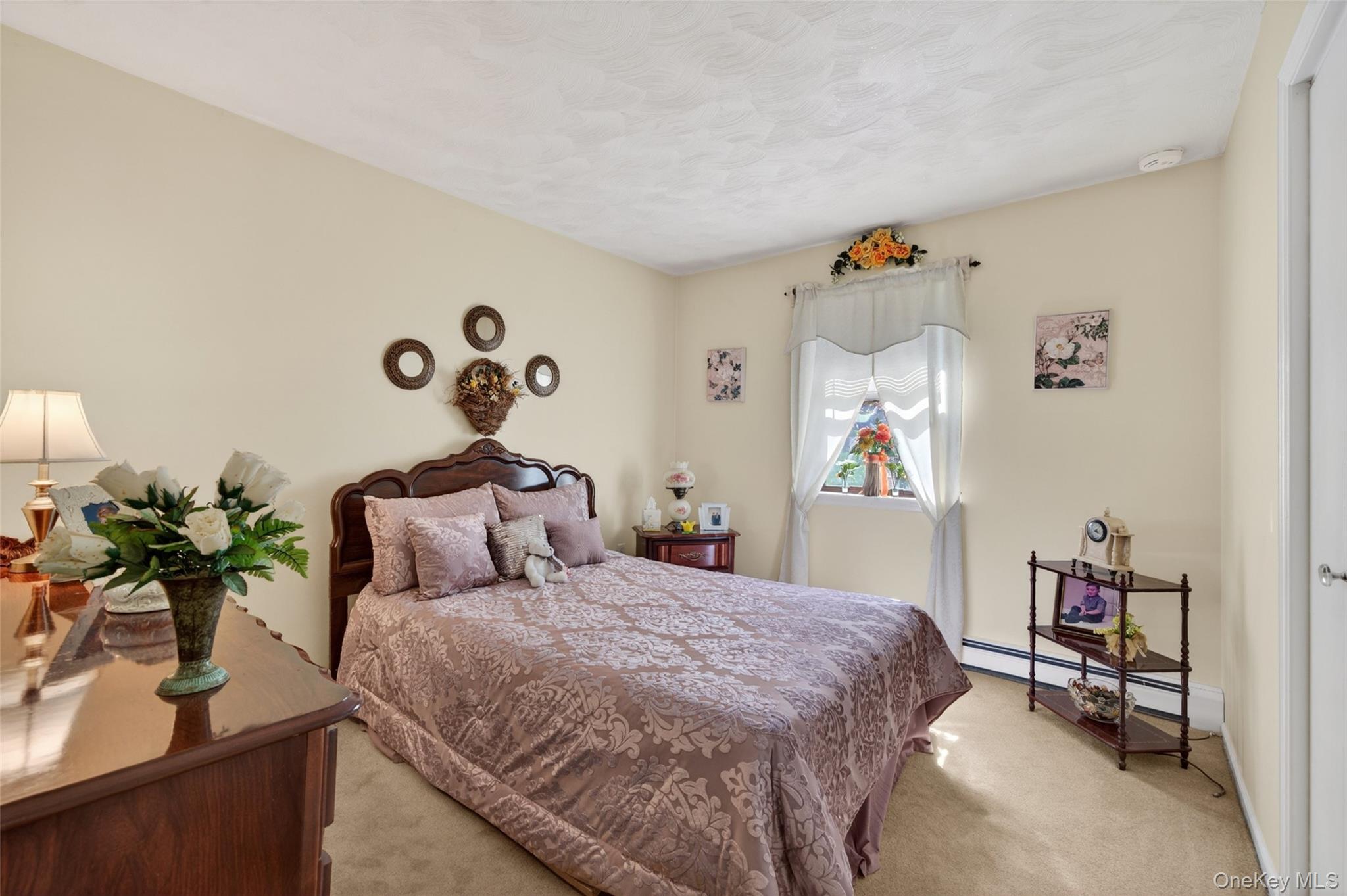 16 Woodward Road Slate Hill, NY 10973 - Photo 27 of 37 a bedroom with a bed and a potted plant on the dresser
