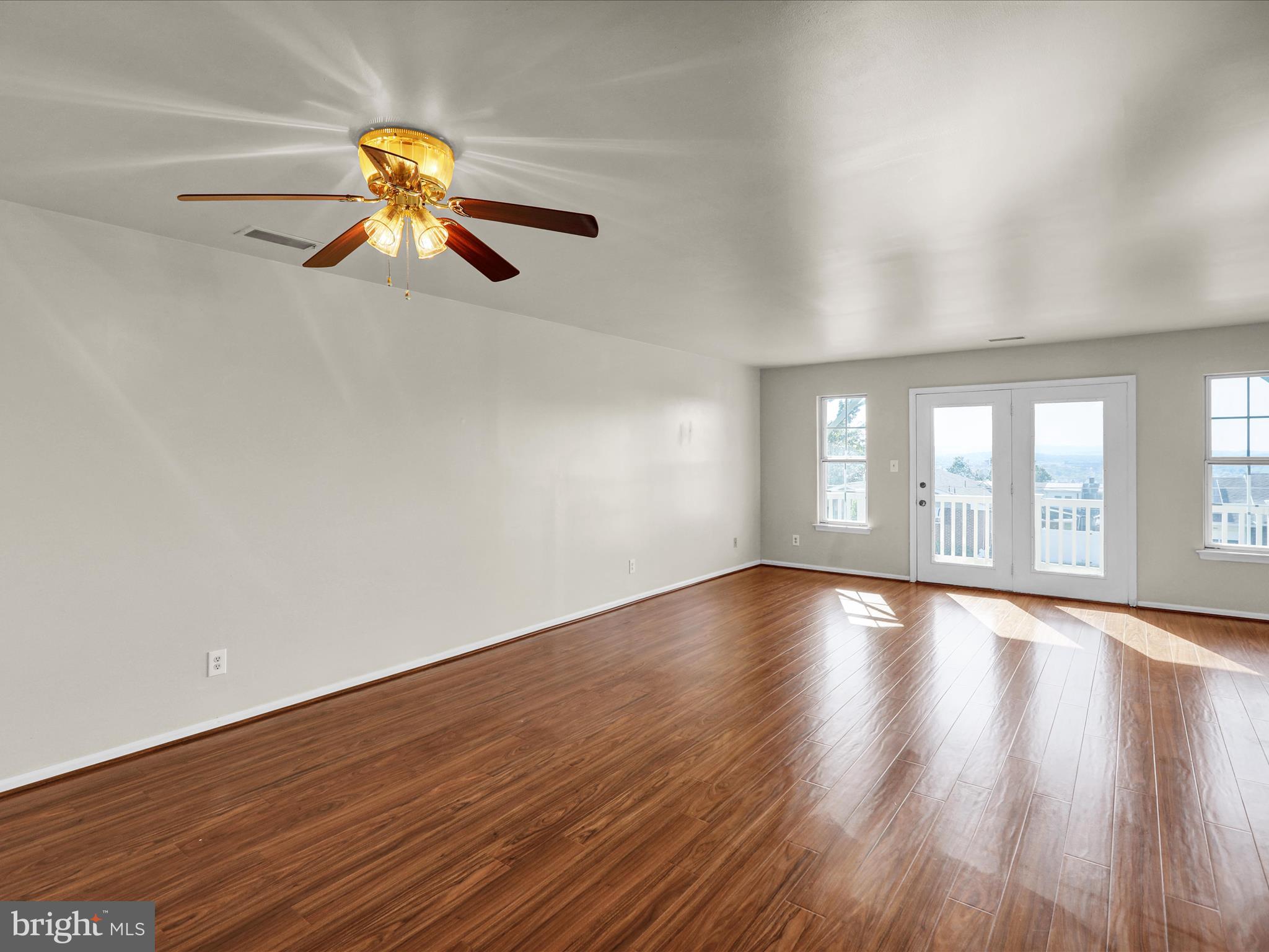 225 North 14th Street Reading, PA 19604 - Photo 5 of 23 a view of an empty room with wooden floor and window