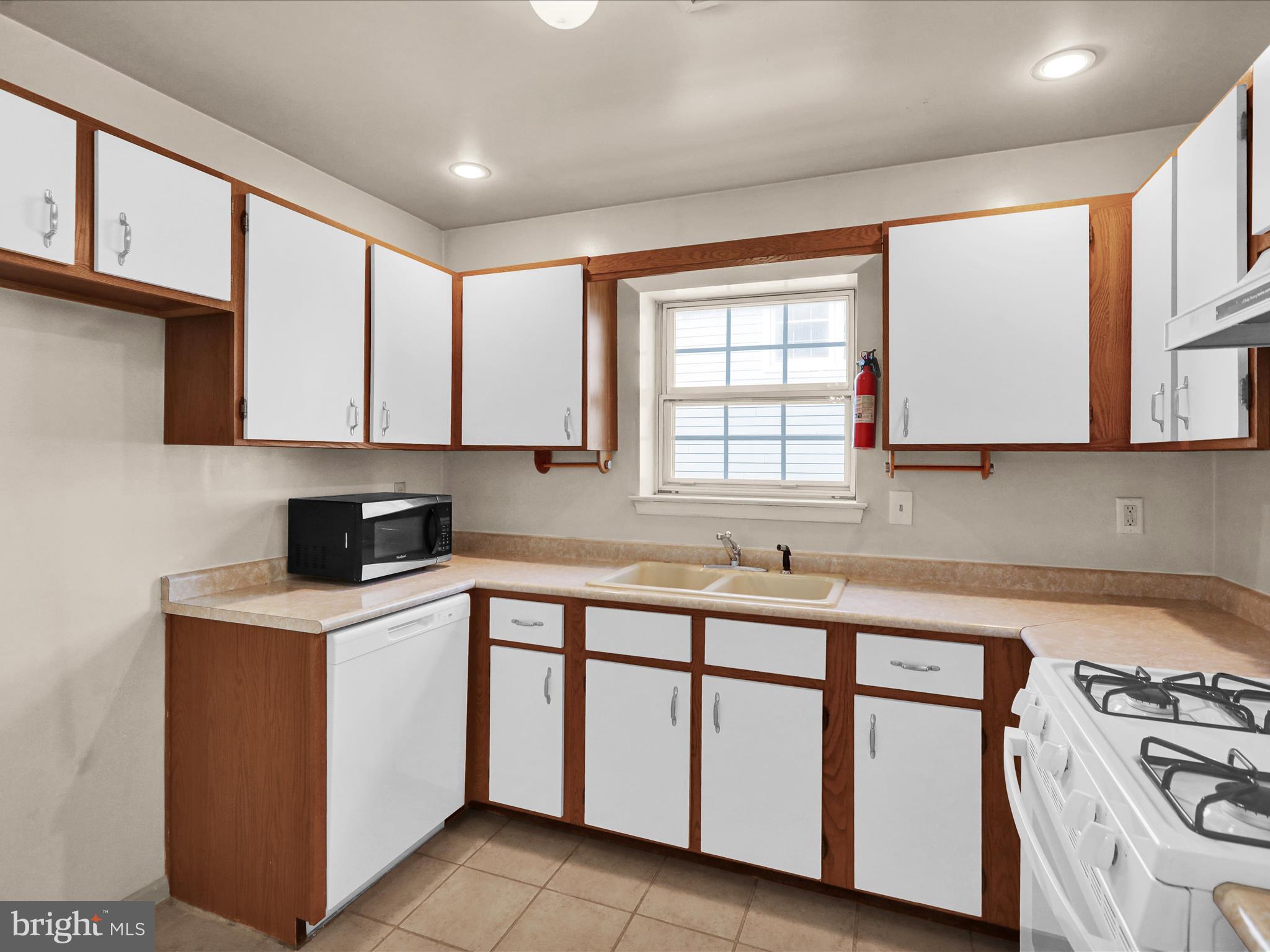 225 North 14th Street Reading, PA 19604 - Photo 7 of 23 a kitchen that has a sink a stove and cabinets