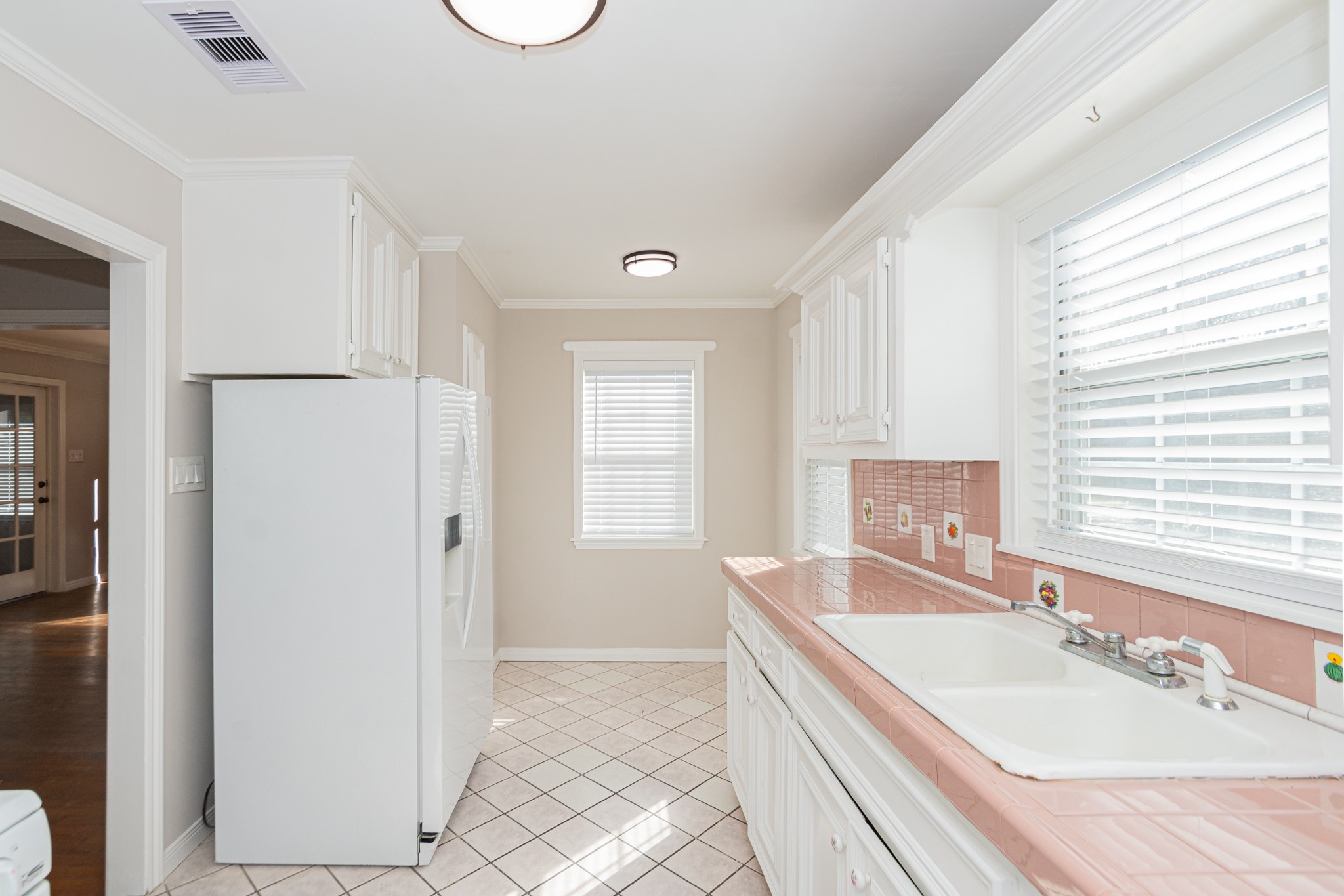 7447 Magnolia Street Houston, TX 77023 - Photo 13 of 38 a bathroom with a granite countertop sink a mirror and a bathtub