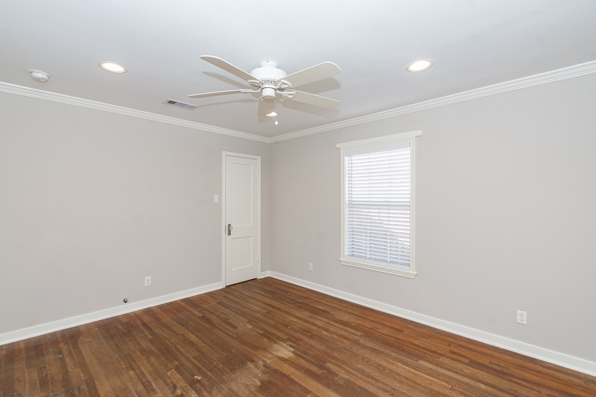 7447 Magnolia Street Houston, TX 77023 - Photo 23 of 38 a view of an empty room with wooden floor and a window
