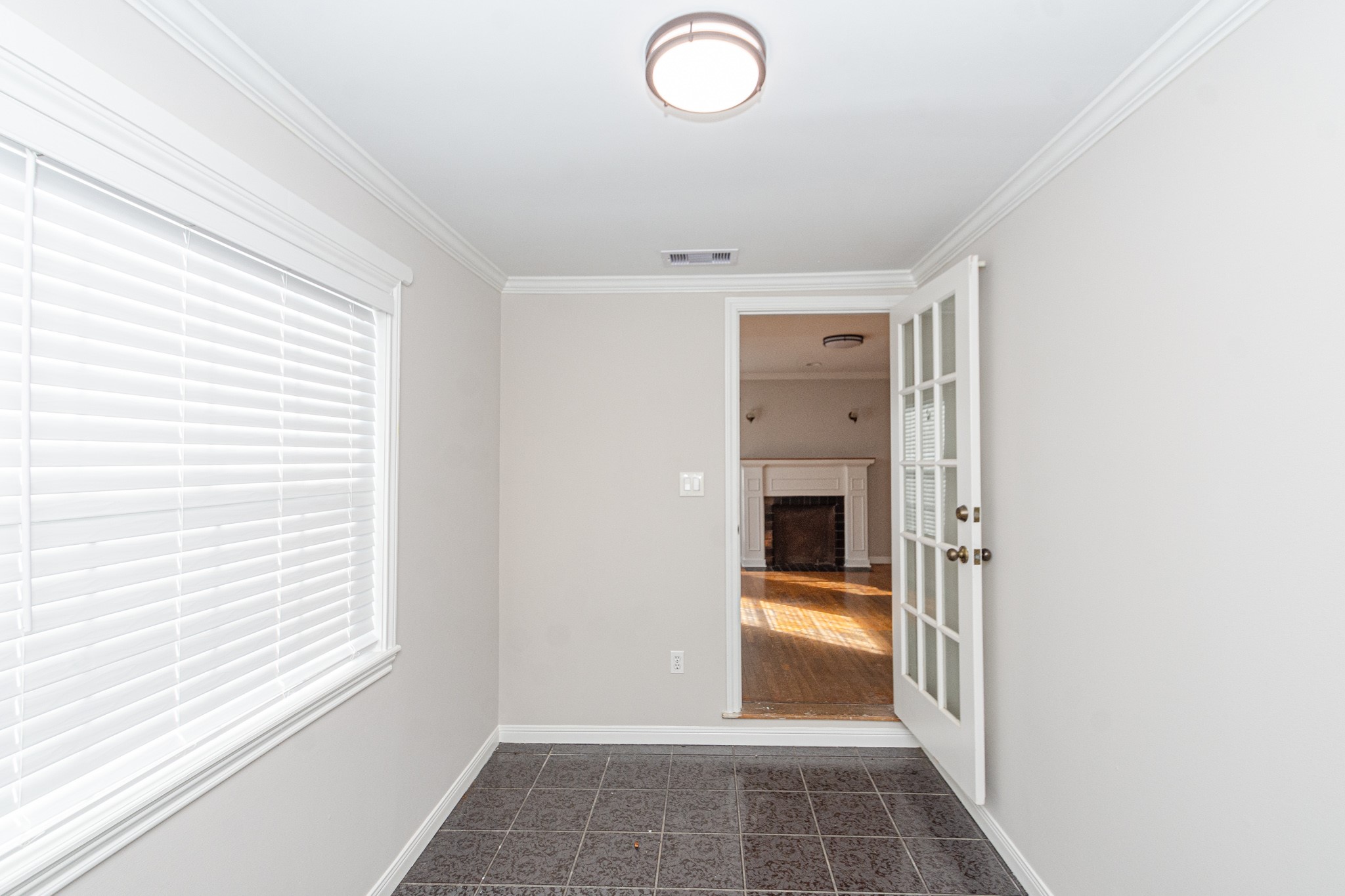 7447 Magnolia Street Houston, TX 77023 - Photo 33 of 38 a view of a hallway with wooden floor and a kitchen