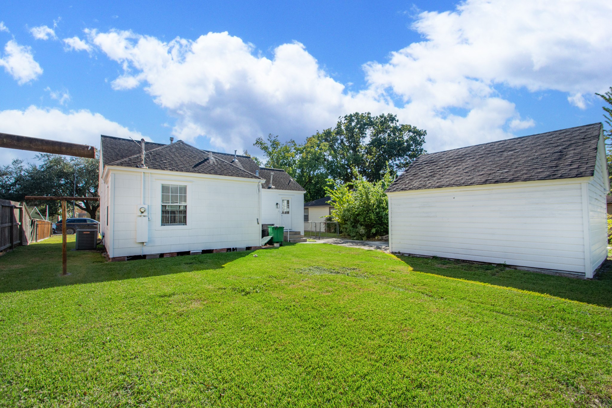 7447 Magnolia Street Houston, TX 77023 - Photo 38 of 38 a view of a backyard with grass and a large tree
