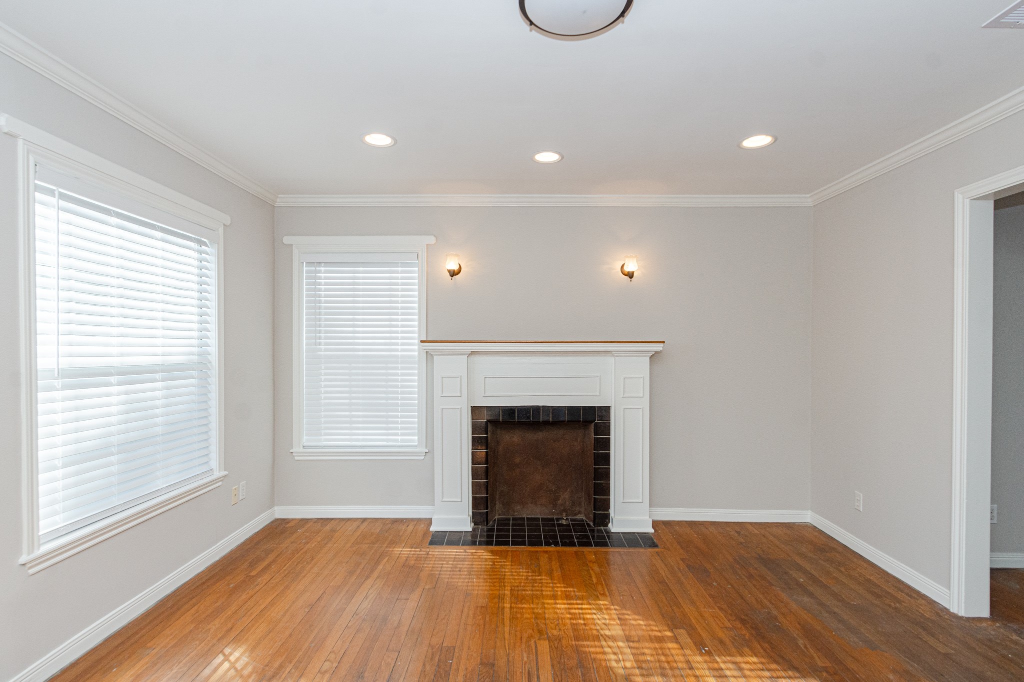 7447 Magnolia Street Houston, TX 77023 - Photo 5 of 38 a view of an empty room with a fireplace and a window