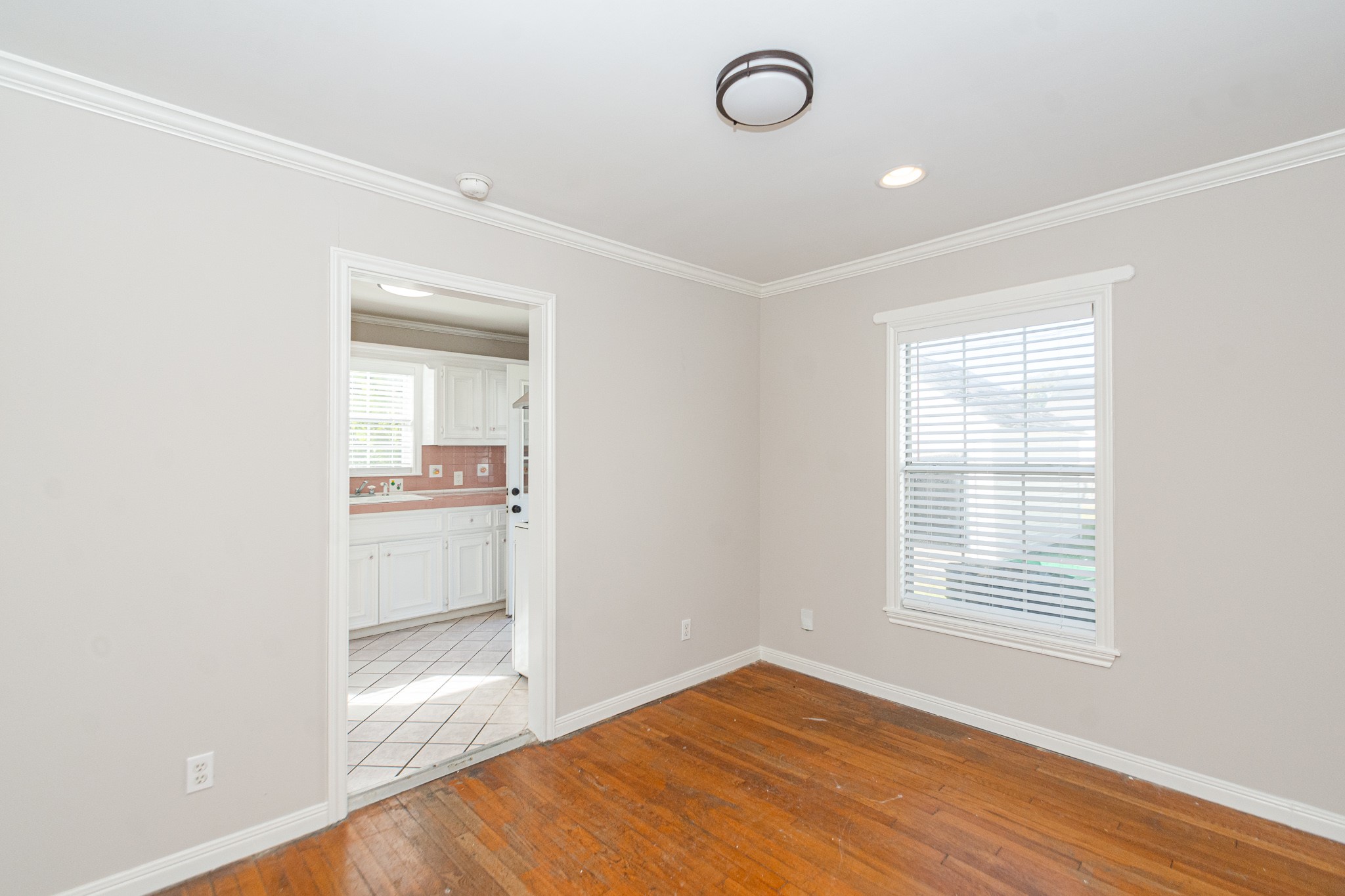 7447 Magnolia Street Houston, TX 77023 - Photo 9 of 38 a view of kitchen and empty room with wooden floor