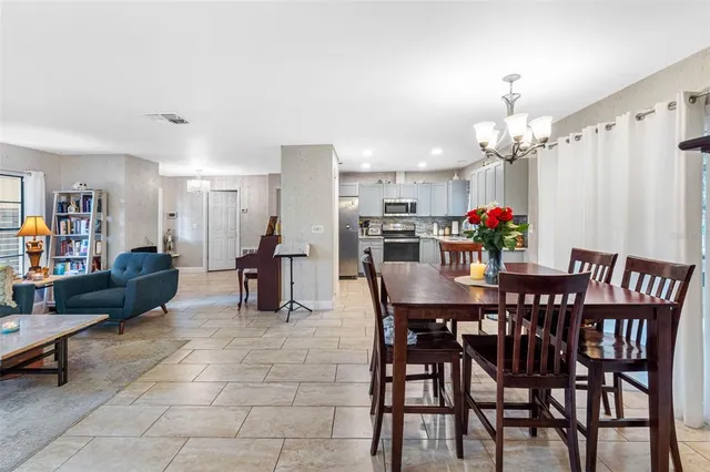 a view of a dining room with furniture and chandelier