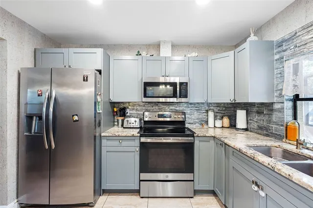 a kitchen with a refrigerator sink and microwave