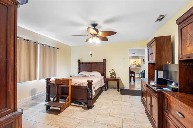 a bed room with a bed and a chandelier