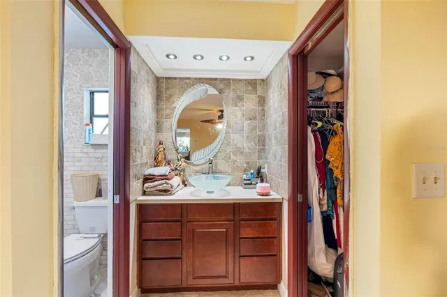 a bathroom with a sink a toilet and a mirror