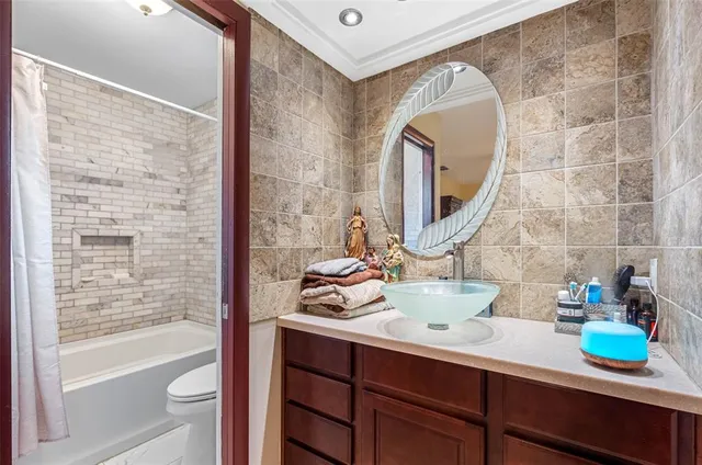 a bathroom with a sink mirror and a bathtub