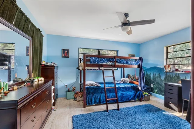 a bedroom with furniture and a window