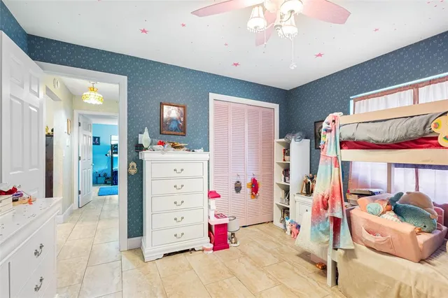 a view of a bedroom with furniture and windows