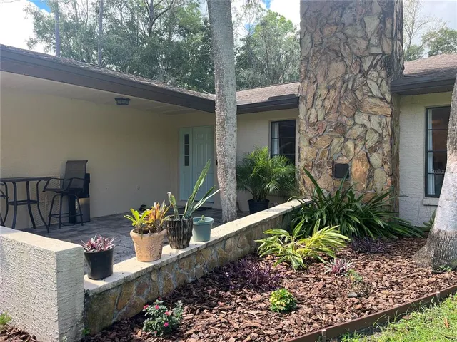 a view of a patio with table and chairs and potted plants