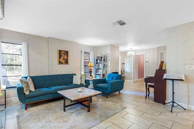 a living room with furniture a rug and a window
