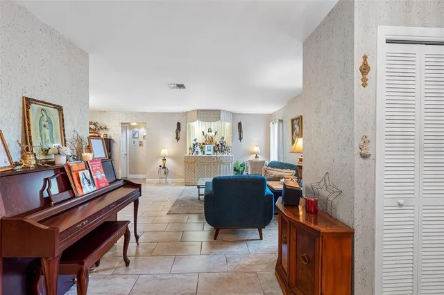 a living room with furniture and a bookshelf