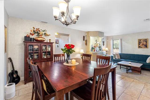 a view of a dining room with furniture and chandelier
